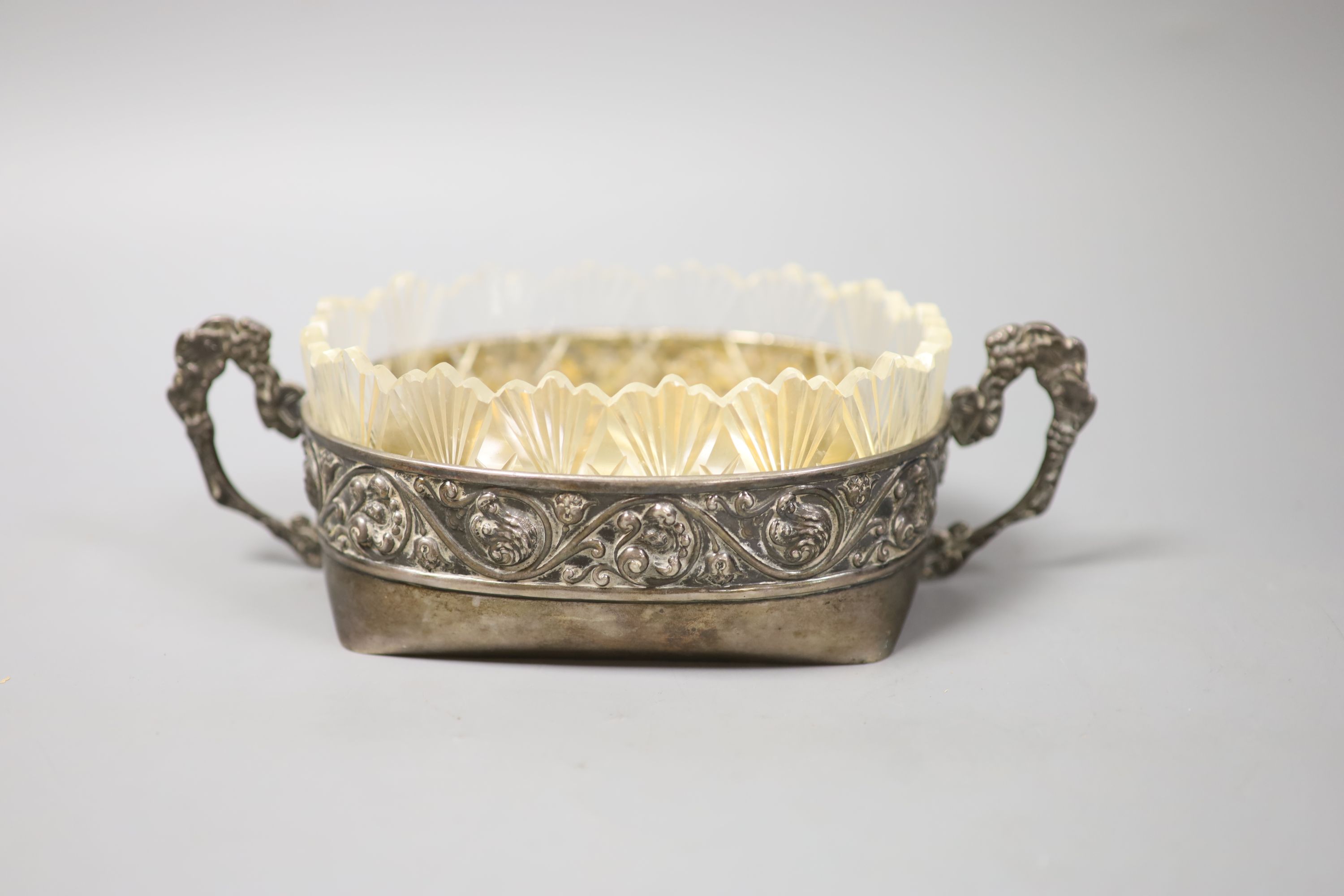 An early 20th century Russian white metal two handled oval dish with glass liner